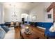 Open-concept living room featuring hardwood floors, elegant lighting, and stylish decor at 830 Grand Hughey Ct, Apopka, FL 32712