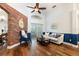 Stylish living room featuring an exposed brick wall and hardwood floors at 830 Grand Hughey Ct, Apopka, FL 32712