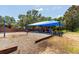 Community playground features a swing set, slide and sunshade in a well-maintained communal space at 830 Grand Hughey Ct, Apopka, FL 32712