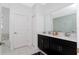 Modern bathroom with dual sink vanity, white marble tile, and a separate soaking tub for a luxurious spa experience at 9312 Sommerset Hills Dr, Davenport, FL 33896