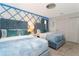 Charming bedroom featuring two beds with plush blue bedding, stylish lighting, and elegant decor at 9312 Sommerset Hills Dr, Davenport, FL 33896