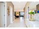 Elegant entryway with decorative mirror, white console table, and open floor plan at 9312 Sommerset Hills Dr, Davenport, FL 33896