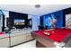 Large game room with pool table, foosball table, video games, large screen television, and a comfortable sofa at 9312 Sommerset Hills Dr, Davenport, FL 33896