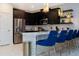 Modern kitchen featuring stainless steel appliances, dark cabinets, and island seating at 9312 Sommerset Hills Dr, Davenport, FL 33896