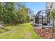 Expansive backyard with lush lawn, mature trees, and a screened patio offering privacy and space at 1013 Maiden Ter, Celebration, FL 34747