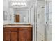 Bathroom featuring a granite countertop vanity, large mirror, and glass enclosed shower with marble surround at 1013 Maiden Ter, Celebration, FL 34747