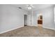 This carpeted bedroom leads into an adjacent bathroom and features neutral walls and trim at 1013 Maiden Ter, Celebration, FL 34747