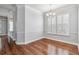 Spacious dining room with hardwood floors, crown molding, plantation shutters, and a decorative chandelier at 1013 Maiden Ter, Celebration, FL 34747