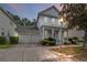 Charming two-story home boasts a well-manicured lawn, inviting porch, and a convenient two-car garage at 1013 Maiden Ter, Celebration, FL 34747