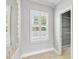 Hallway features plantation shutters, neutral walls and tile flooring, plus a reach-in closet at 1013 Maiden Ter, Celebration, FL 34747