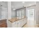 Bright kitchen with granite countertops, white cabinetry, and views into adjacent rooms at 1013 Maiden Ter, Celebration, FL 34747