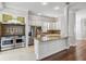 Open concept kitchen with stainless steel appliances, a large island, and white cabinetry at 1013 Maiden Ter, Celebration, FL 34747