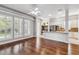 Open concept living room featuring hardwood floors, windows with shutters, and views into kitchen at 1013 Maiden Ter, Celebration, FL 34747