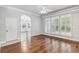 Open living room area with hardwood floors and natural light entering from the many windows at 1013 Maiden Ter, Celebration, FL 34747