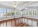 Bright living room featuring hardwood floors and lots of natural light from large windows at 1013 Maiden Ter, Celebration, FL 34747