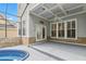 Covered patio with ceiling fan, spa and stone accents, perfect for outdoor relaxation and entertaining at 1013 Maiden Ter, Celebration, FL 34747