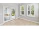 Sunroom with tile floors, natural light, and door to exterior at 1013 Maiden Ter, Celebration, FL 34747