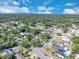 Wide aerial view of a residential neighborhood with mature trees and single-Gathering homes under a sunny sky at 1030 Gran Paseo Dr, Orlando, FL 32825