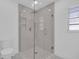 Bathroom featuring a modern shower with clear glass doors, a white toilet, and a tiled interior at 1030 Gran Paseo Dr, Orlando, FL 32825