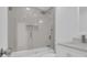 Bathroom with shower-tub combo and glass enclosure plus white vanity with solid surface counter at 1030 Gran Paseo Dr, Orlando, FL 32825