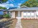 Attractive front entrance highlighting the brick accents, white door, and small landscaping details at 1030 Gran Paseo Dr, Orlando, FL 32825