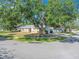 Charming home with mature trees, well-manicured lawn, and welcoming curb appeal at 1030 Gran Paseo Dr, Orlando, FL 32825