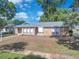 Inviting single-story home featuring a brick exterior, updated windows, and a neatly landscaped front yard at 1030 Gran Paseo Dr, Orlando, FL 32825