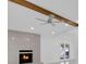 Living room with fireplace and stone surround, beamed ceiling and white walls at 1030 Gran Paseo Dr, Orlando, FL 32825
