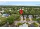 This aerial view pinpoints a neighborhood near a serene lake amidst lush greenery at 1105 Mill Run Cir, Apopka, FL 32703