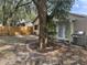 Fenced backyard featuring a large tree and a stainless steel grill at 1105 Mill Run Cir, Apopka, FL 32703