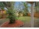 A spacious backyard featuring lush landscaping and mature trees, creating a private oasis at 1105 Mill Run Cir, Apopka, FL 32703