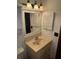 Bathroom featuring a vanity with a mirror, cabinet, and a three light fixture above at 1105 Mill Run Cir, Apopka, FL 32703