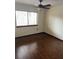 Bedroom with wood flooring, a ceiling fan, and a window providing natural light at 1105 Mill Run Cir, Apopka, FL 32703