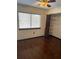 Bedroom featuring hardwood floors, window with blinds, closet, and an overhead ceiling fan at 1105 Mill Run Cir, Apopka, FL 32703
