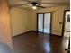 This bedroom features hardwood floors, a ceiling fan, and a sliding glass door leading to the outside at 1105 Mill Run Cir, Apopka, FL 32703