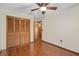 Bedroom boasts wood floors and a ceiling fan at 1105 Mill Run Cir, Apopka, FL 32703