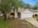 Charming single-Gathering home with a well-kept lawn, a two-car garage, and tasteful landscaping at 1105 Mill Run Cir, Apopka, FL 32703