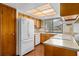 Functional kitchen with appliances, wood cabinets, and a window offering natural light at 1105 Mill Run Cir, Apopka, FL 32703
