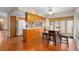 Bright eat-in kitchen with wooden cabinets, ceiling fan, and hardwood flooring at 1105 Mill Run Cir, Apopka, FL 32703