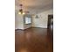 Spacious living room featuring hardwood floors, natural light, ceiling fan and hanging light fixture at 1105 Mill Run Cir, Apopka, FL 32703