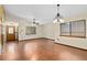 Spacious living room featuring hardwood floors, ceiling fans, and abundant natural light at 1105 Mill Run Cir, Apopka, FL 32703