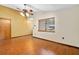 Living room with wood floors, a ceiling fan, and a window with natural lighting at 1105 Mill Run Cir, Apopka, FL 32703