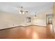 Open living room with hardwood floors, ceiling fan, and natural light from the window at 1105 Mill Run Cir, Apopka, FL 32703
