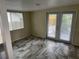 Bright room with tile flooring, a window, and glass patio doors at 1105 Mill Run Cir, Apopka, FL 32703