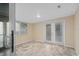 Bright sunroom featuring tile flooring and double doors leading to the backyard at 1105 Mill Run Cir, Apopka, FL 32703