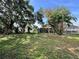 Expansive backyard with mature trees and lush lawn perfect for outdoor activities at 132 Acapulco Dr, Kissimmee, FL 34743