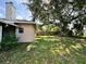 Backyard featuring mature tree providing shade and privacy at 132 Acapulco Dr, Kissimmee, FL 34743