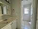 Bright bathroom with a single sink vanity and separate toilet and shower at 132 Acapulco Dr, Kissimmee, FL 34743