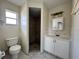 Bathroom featuring a vanity, mirror, toilet, and a stand-up shower at 132 Acapulco Dr, Kissimmee, FL 34743