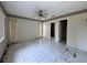 Bedroom featuring tile flooring, two windows, and access to an ensuite bathroom at 132 Acapulco Dr, Kissimmee, FL 34743